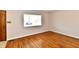 Living room with wood flooring and a bright window, providing natural light at 7953 Forest Park Dr, Indianapolis, IN 46217