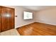 Bright living room with hardwood floors, large window, and a beautiful wooden front door at 7953 Forest Park Dr, Indianapolis, IN 46217
