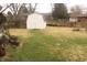 View of the home's spacious backyard, including a white storage shed at 8137 S Delaware St, Indianapolis, IN 46227