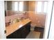 Well-lit bathroom with a large vanity, updated fixtures, and a toilet at 8137 S Delaware St, Indianapolis, IN 46227