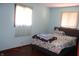 Modest bedroom with wood-look flooring and two windows for natural light at 8137 S Delaware St, Indianapolis, IN 46227