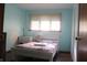Cozy bedroom with a bright window, neutral walls, and hardwood flooring at 8137 S Delaware St, Indianapolis, IN 46227