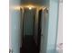Hallway with hardwood floors, neutral paint, and ample closet space at 8137 S Delaware St, Indianapolis, IN 46227