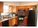 Kitchen with stainless steel appliances, ample wood cabinets, and decorative backsplash at 8137 S Delaware St, Indianapolis, IN 46227