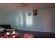 Bright living room featuring hardwood floors, light blue walls, and a ceiling fan at 8137 S Delaware St, Indianapolis, IN 46227