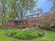 Backyard featuring a brick exterior, lush greenery, stone accents and outdoor seating at 8510 N Park Ave, Indianapolis, IN 46240