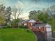 Traditional brick home boasts lush landscaping, well-manicured lawn, and inviting curb appeal at 8510 N Park Ave, Indianapolis, IN 46240