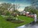 Lush green lawn surrounds beautiful home with mature trees and manicured gardens, showcasing curb appeal at 8510 N Park Ave, Indianapolis, IN 46240
