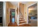 Bright hallway with hardwood floors, staircase, and entryways to the living room and kitchen at 8510 N Park Ave, Indianapolis, IN 46240