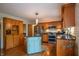 Charming kitchen with a blue island, wooden cabinets, stainless steel appliances, and granite countertops at 8510 N Park Ave, Indianapolis, IN 46240