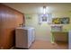 Laundry room with a washer and dryer, painted block walls, and a small window at 8510 N Park Ave, Indianapolis, IN 46240