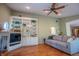 Comfortable living room with hardwood floors, a ceiling fan, built-in shelves, and a cozy couch for relaxation at 8510 N Park Ave, Indianapolis, IN 46240