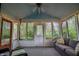 Enclosed sunroom with a comfortable sofa, string lights, a ceiling fan, and multiple windows offering outdoor views at 8510 N Park Ave, Indianapolis, IN 46240