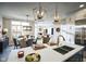 Open-concept kitchen and dining area with pendant lighting, stainless appliances, and hardwood floors at 9163 Bryce Cir, Zionsville, IN 46077