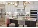 Modern kitchen featuring stainless steel appliances, white cabinets, and a large island with seating at 9163 Bryce Cir, Zionsville, IN 46077