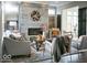Cozy living room with a modern fireplace, plush seating, and abundant natural light at 9163 Bryce Cir, Zionsville, IN 46077
