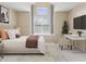 Bright bedroom features a large window, patterned rug, bed, and desk with ample natural light at 9459 Wimbledon Ct, Indianapolis, IN 46250