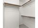 Walk-in closet with shelves and rods for organized storage at 9459 Wimbledon Ct, Indianapolis, IN 46250