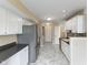 Efficient kitchen with white cabinets, stainless steel appliances, and decorative backsplash at 9459 Wimbledon Ct, Indianapolis, IN 46250