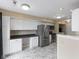 Bright kitchen with white cabinets, stainless steel appliances, and marble-look floors at 9459 Wimbledon Ct, Indianapolis, IN 46250