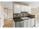 Functional kitchen space featuring tile backsplash, laminate floors, and white cabinetry at 9459 Wimbledon Ct, Indianapolis, IN 46250