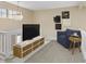 Cozy living room features a plush blue chair, side table, and modern entertainment center at 9459 Wimbledon Ct, Indianapolis, IN 46250