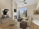 Bright living room with vaulted ceilings, fireplace, large window, and stylish furnishings at 9459 Wimbledon Ct, Indianapolis, IN 46250