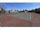 An outdoor tennis court with a green and red court surface surrounded by houses in the background at 9459 Wimbledon Ct, Indianapolis, IN 46250