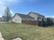 Backyard with a brown wooden fence, some green trees, and the back of the home at 950 Kempson Ct, Westfield, IN 46074