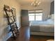 Cozy bedroom with a queen bed, wood floors, natural light, and modern lighting fixtures at 950 Kempson Ct, Westfield, IN 46074