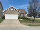 Charming single-story brick home featuring an attached two-car garage and a well-maintained front yard at 950 Kempson Ct, Westfield, IN 46074