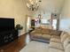 Cozy living room with hardwood floors, chandeliers, and open floor plan at 950 Kempson Ct, Westfield, IN 46074