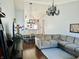 Open-concept living and dining area featuring a comfortable sofa, chandelier, and seamless flow between spaces at 950 Kempson Ct, Westfield, IN 46074