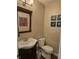 Well-lit bathroom with a decorative mirror, stylish vanity, and modern toilet at 9649 Cedar Cove Ln, Indianapolis, IN 46250
