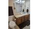 Bright bathroom featuring a white sink, a brown cabinet and a large mirror at 9649 Cedar Cove Ln, Indianapolis, IN 46250
