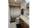 Bathroom with a shower/tub, neutral-toned tile, wood cabinets and laminate countertops at 9649 Cedar Cove Ln, Indianapolis, IN 46250