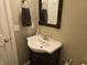 Charming bathroom featuring a vanity with a sink, framed mirror, and neutral decor at 9649 Cedar Cove Ln, Indianapolis, IN 46250