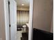Bathroom view from doorway, featuring a shower with curtains, and a white toilet at 9649 Cedar Cove Ln, Indianapolis, IN 46250