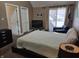Bedroom featuring a large bed, TV, chair and footstool with plenty of natural light at 9649 Cedar Cove Ln, Indianapolis, IN 46250