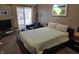 Cozy bedroom with modern decor, carpet, and a comfortable leather armchair with view at 9649 Cedar Cove Ln, Indianapolis, IN 46250