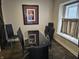 Well lit dining room featuring a modern glass table, black chairs, and a picture window at 9649 Cedar Cove Ln, Indianapolis, IN 46250