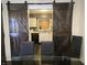 View of the kitchen through rustic barn doors in the dining room at 9649 Cedar Cove Ln, Indianapolis, IN 46250