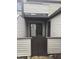 View of exterior of home with private front entry gate and sliding glass door to the outdoor space at 9649 Cedar Cove Ln, Indianapolis, IN 46250
