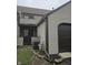 Exterior corner of townhouse, featuring neutral siding, garage access, and an A/C unit at 9649 Cedar Cove Ln, Indianapolis, IN 46250