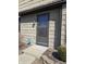 Close-up of the front entrance, showcasing the door, exterior light fixture, and security system at 9649 Cedar Cove Ln, Indianapolis, IN 46250