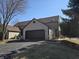 View of the home's spacious two-car garage and driveway, offering convenient parking and storage at 9649 Cedar Cove Ln, Indianapolis, IN 46250