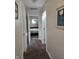 Hallway leading to a bedroom with neutral walls and carpet flooring at 9649 Cedar Cove Ln, Indianapolis, IN 46250