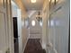 Hallway with chandelier, framed pictures, and oval window, enhancing a bright and inviting space at 9649 Cedar Cove Ln, Indianapolis, IN 46250