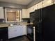 Modern kitchen with white cabinets, granite countertops, and a view into the dining room at 9649 Cedar Cove Ln, Indianapolis, IN 46250