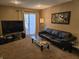 Comfortable living room with a large window, TV, and relaxing black leather seating at 9649 Cedar Cove Ln, Indianapolis, IN 46250